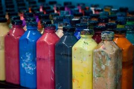 Rows of colorful paint bottles inside the Mudbug Art studio.